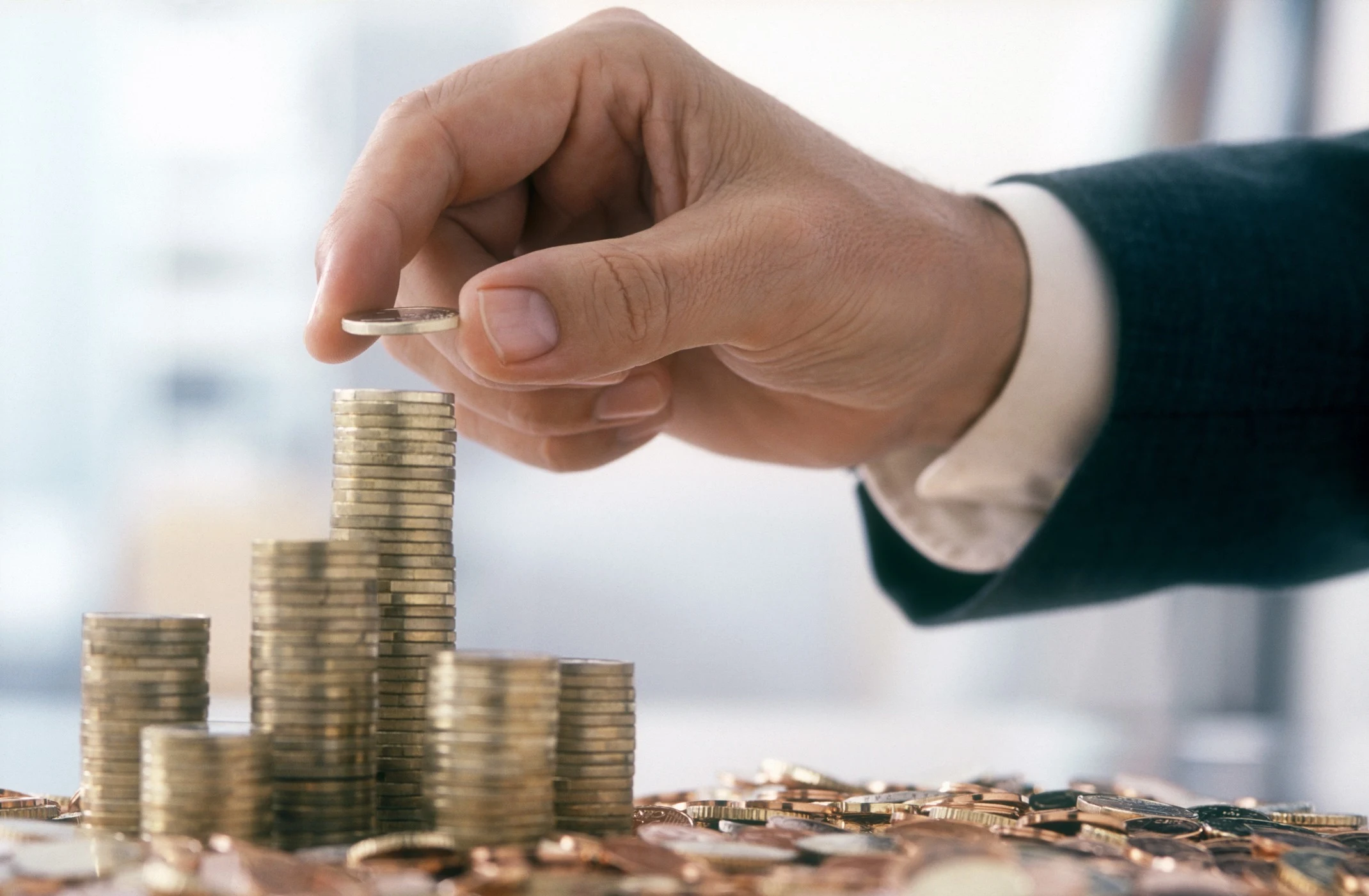 businessman stacking coins financial growth