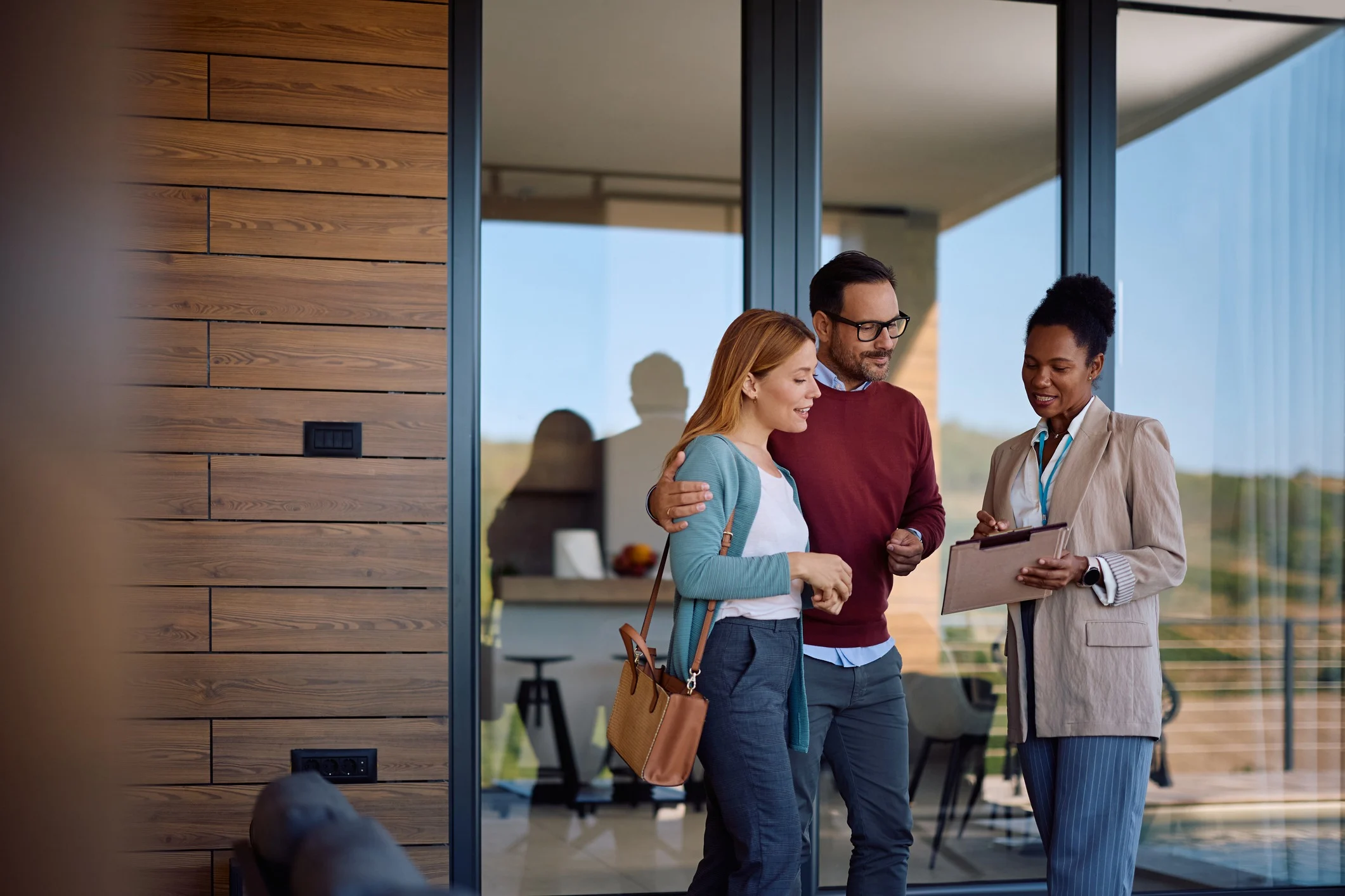 couple real estate agent reviewing property documents
